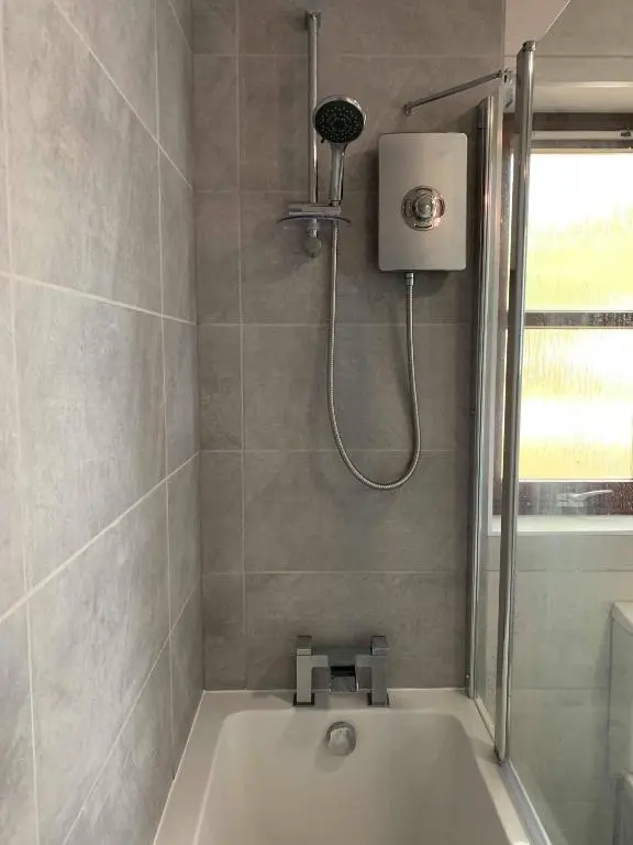 a bathroom with a shower and a bath tub at Rendezvous , Aviemore in Aviemore