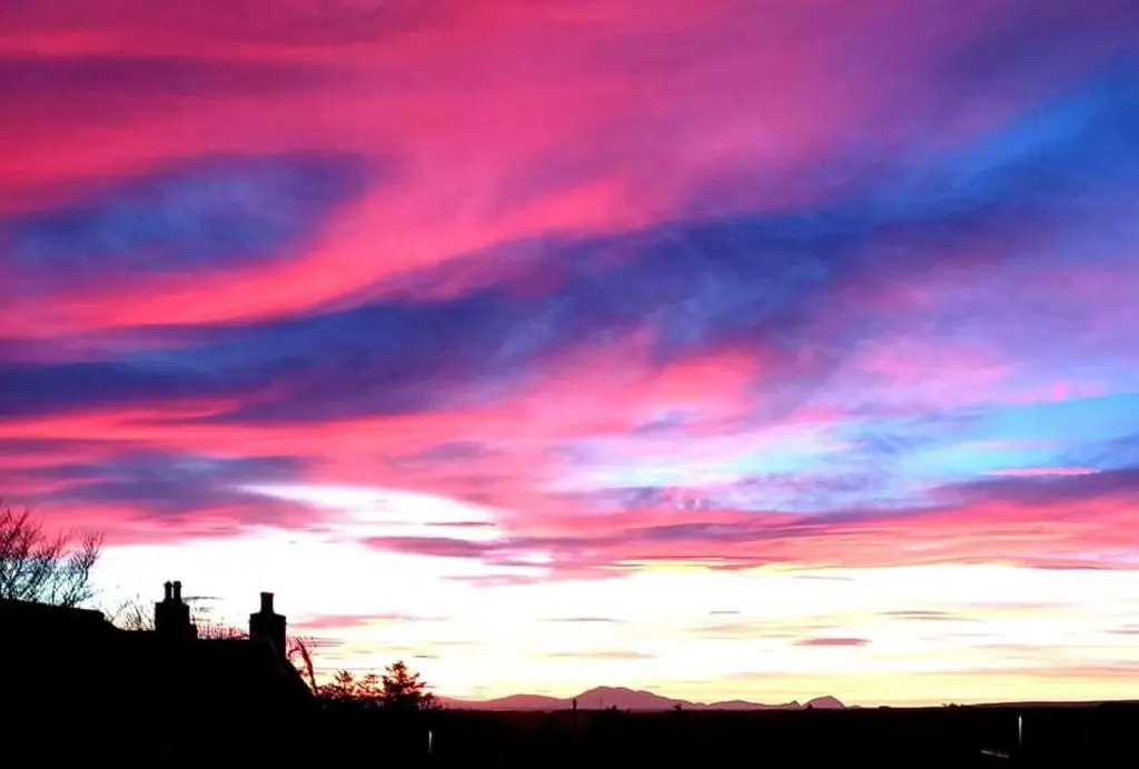 a sunset with a pink in the sky at North Star Glamping in Lybster