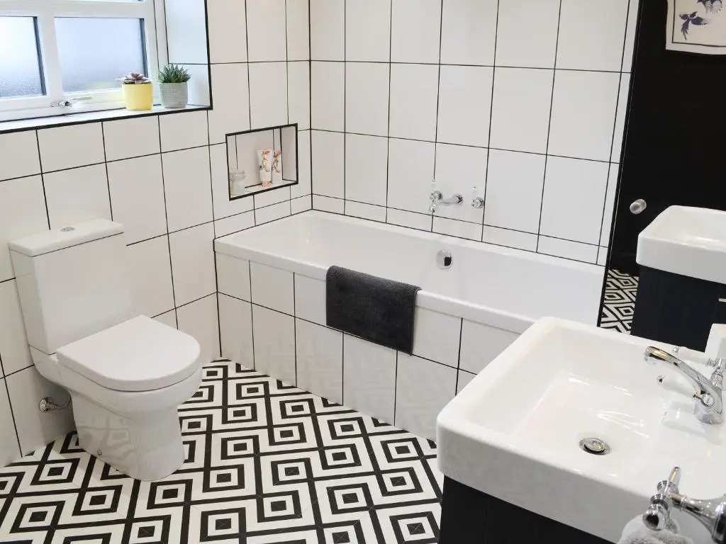 a bathroom with a toilet and a sink at Mile End Cottage in Inverness