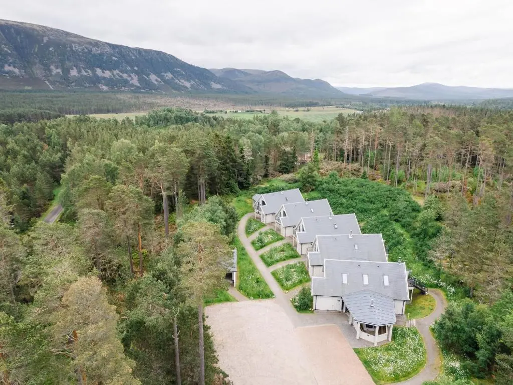 an aerial view of a house in the woods at Red Deer Lodge in Kingussie