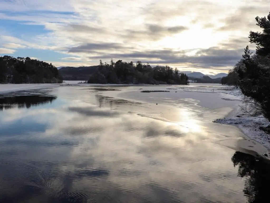 a view of a river with clouds in the water at Wildcat Lodge in Kingussie