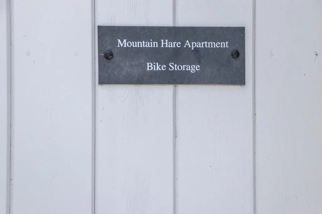 a sign that reads mountain have apartment bike storage at Mountain Hare Apartment in Kingussie