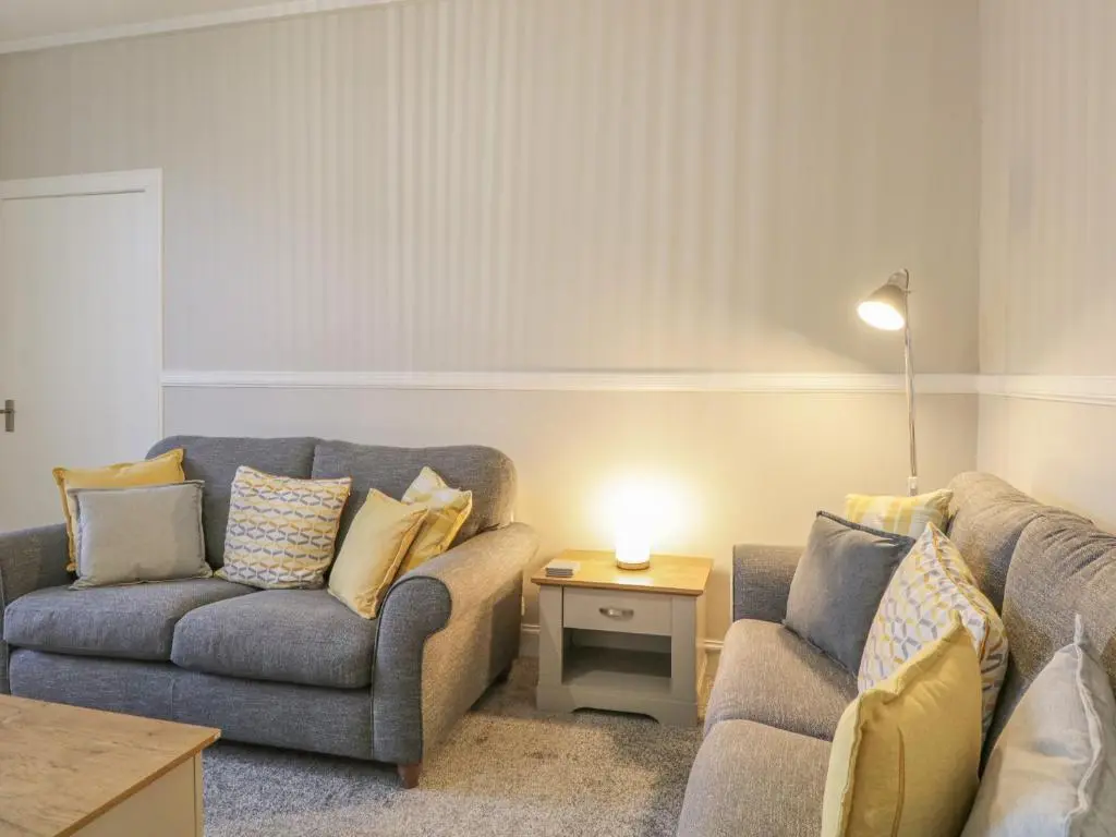 a living room with two couches and a table at The Neuk in Elgin