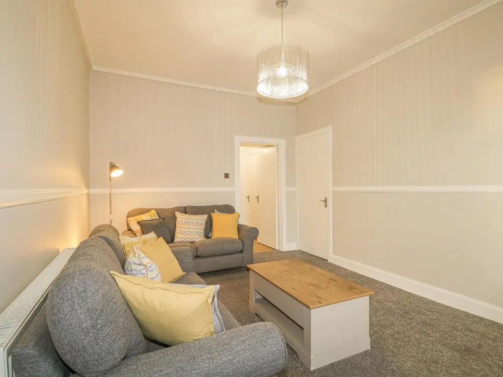 a living room with a couch and a table at The Neuk in Elgin