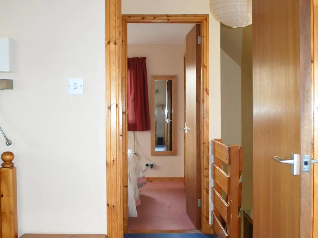 a hallway with a door leading into a room at Callachy Cottage - Uk7047 in Glenurguhart
