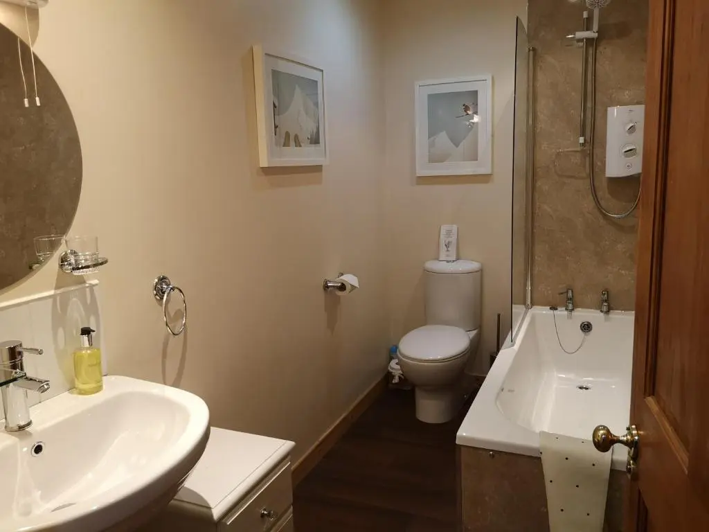 a bathroom with a sink and a toilet and a shower at Cranford Guest House in Braemar