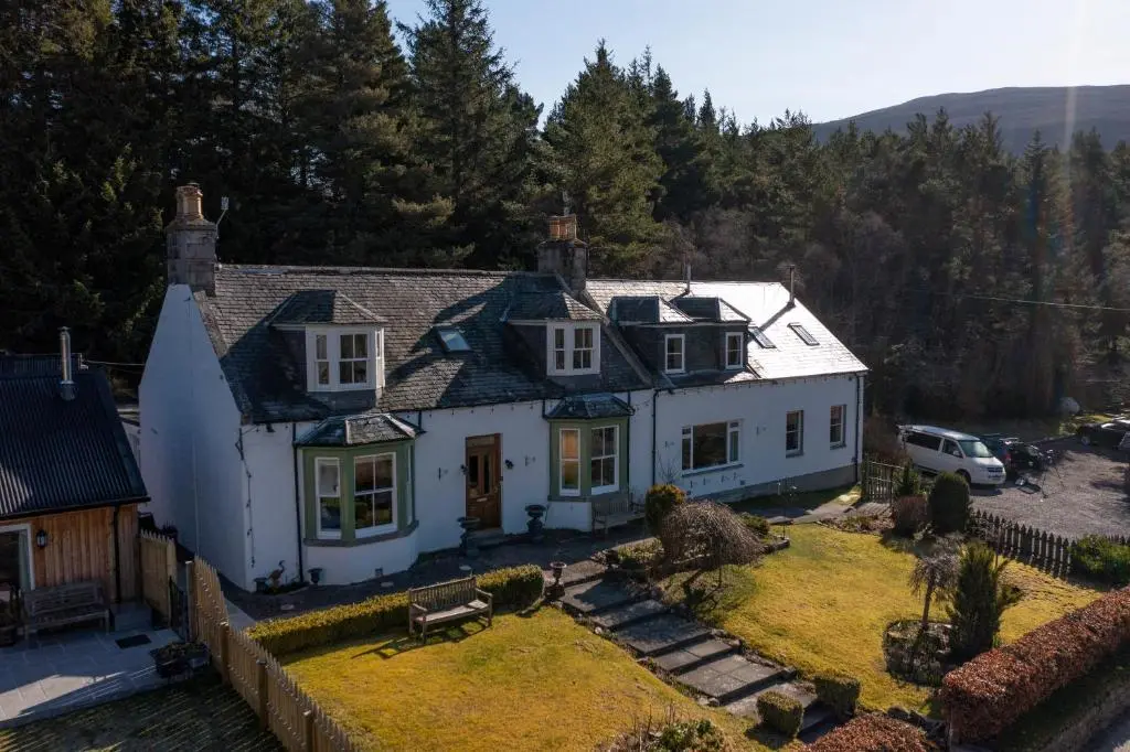 an aerial view of a white house with a yard at Cranford Guest House in Braemar