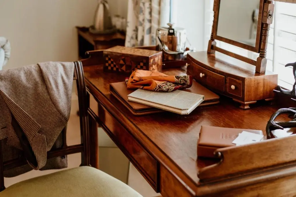 a wooden desk with a mirror and a purse on it at Links House at Royal Dornoch in Dornoch