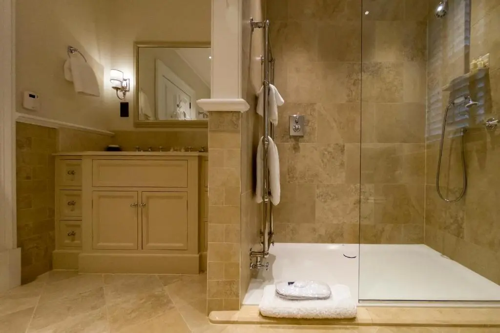 a bathroom with a shower and a bath tub at Links House at Royal Dornoch in Dornoch