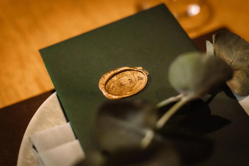 a coin sitting on a table next to a plant at Links House at Royal Dornoch in Dornoch