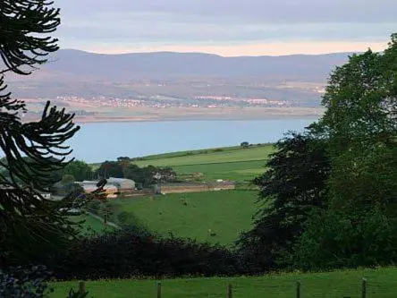 a view of a green field with a large body of water at Pine Lodge - Uk7049 in Glenurguhart