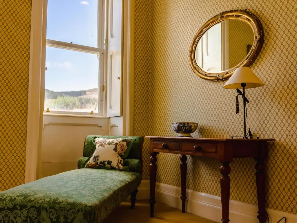 a room with a chair and a table and a mirror at Dalnaglar Castle - Uk7072 in Cray