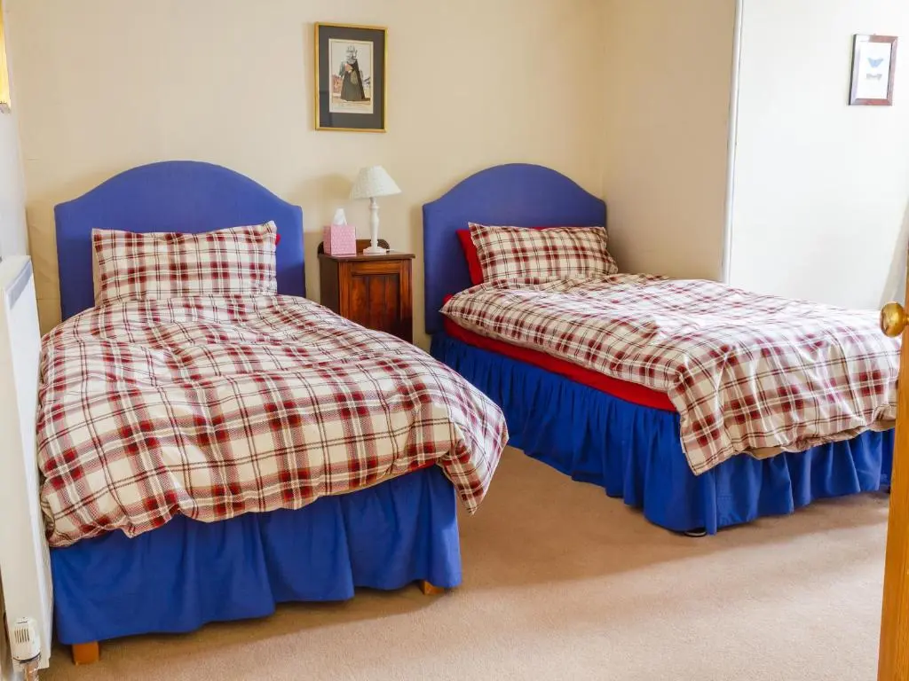 two beds sitting next to each other in a bedroom at Dalnaglar Castle - Uk7072 in Cray