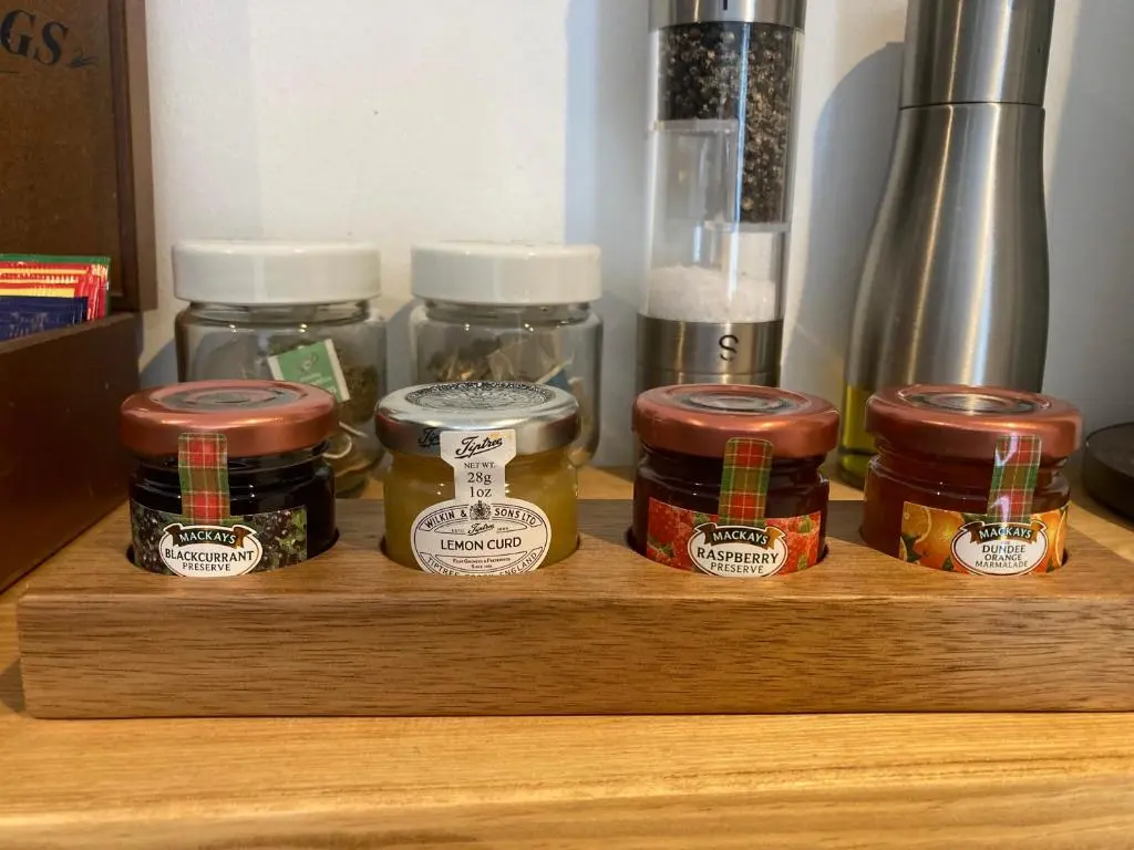 a wooden shelf with jars of food on it at Clashmore Wood in Dornoch
