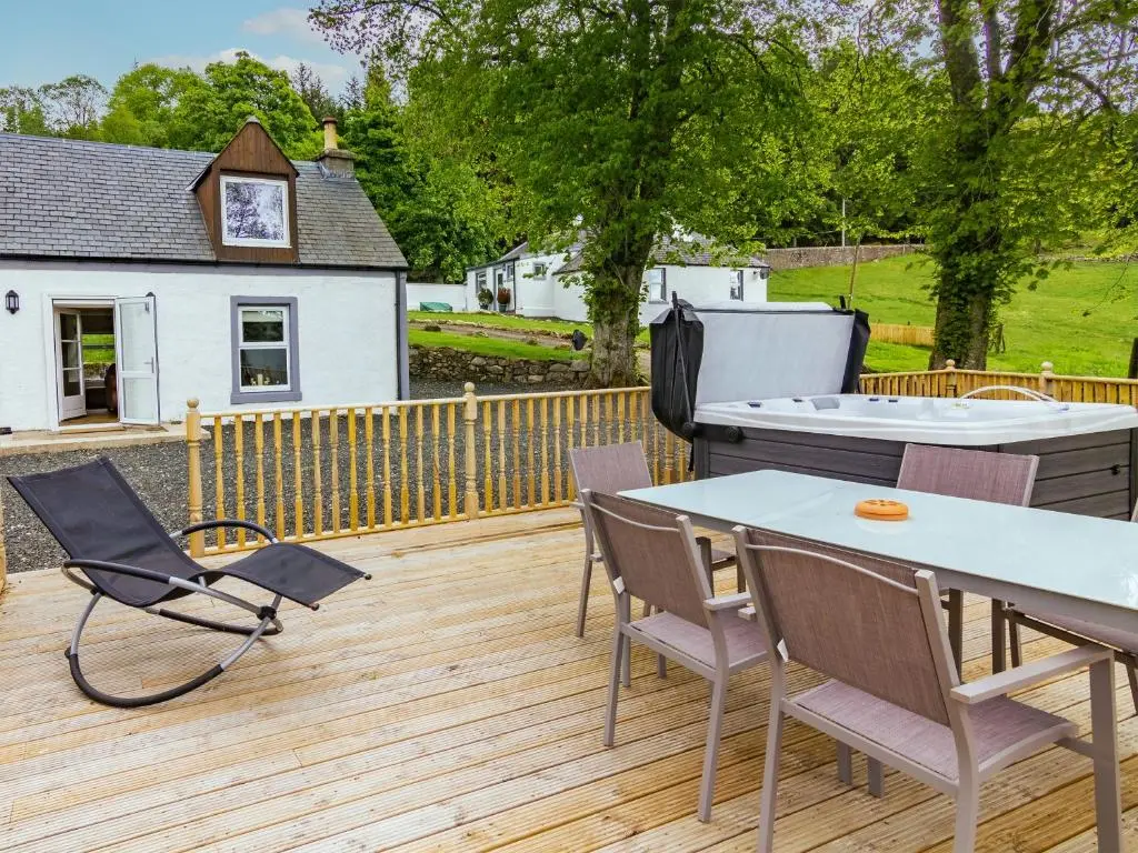 a patio with a table and chairs and a grill at Dalnaglar Cottage - Uk30260 in Cray