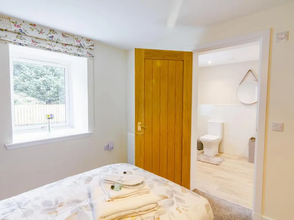 a bedroom with a bed and a window and a toilet at Easter Caiplich - Uk30263 in Cray