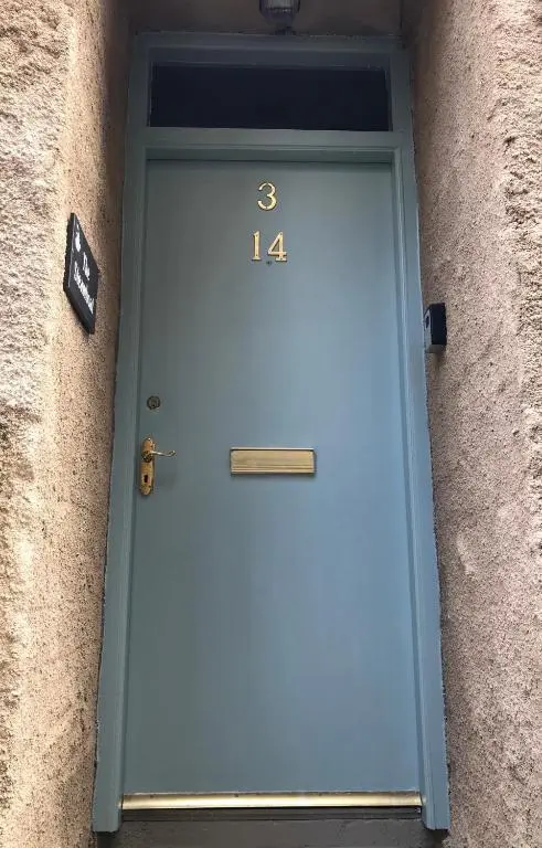 a blue door with the number on it at The Steamboat - A Flat with Amazing Harbour Views in Wick