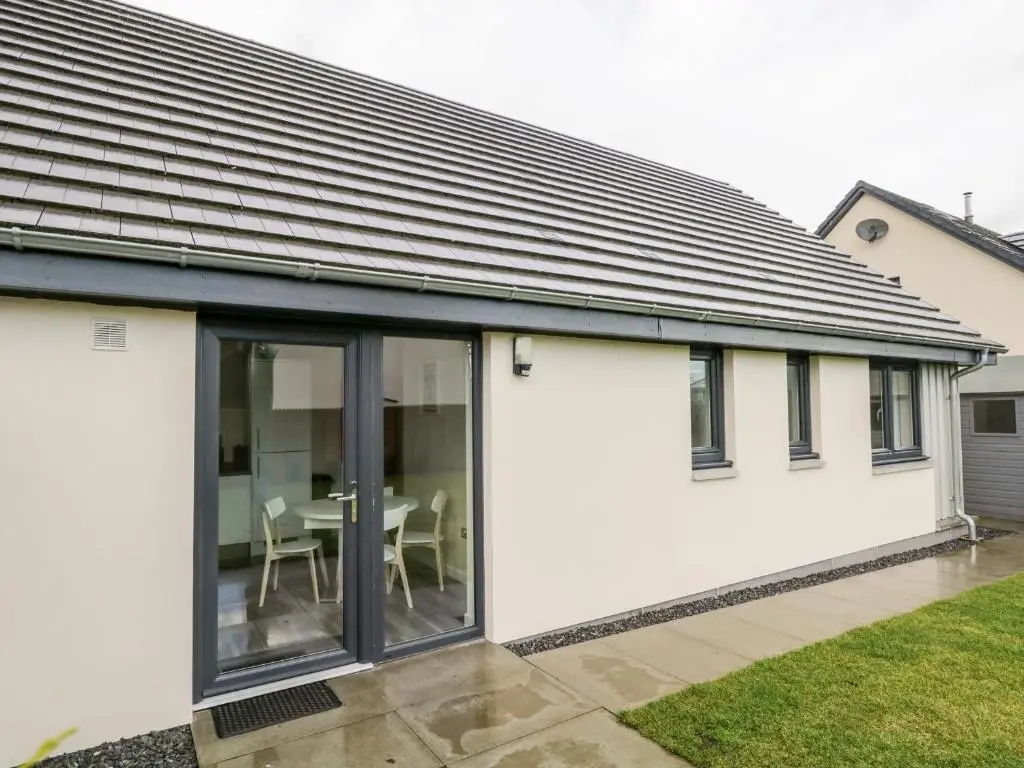 an extension to a house with sliding glass doors at Skoglendi in Boat of Garten