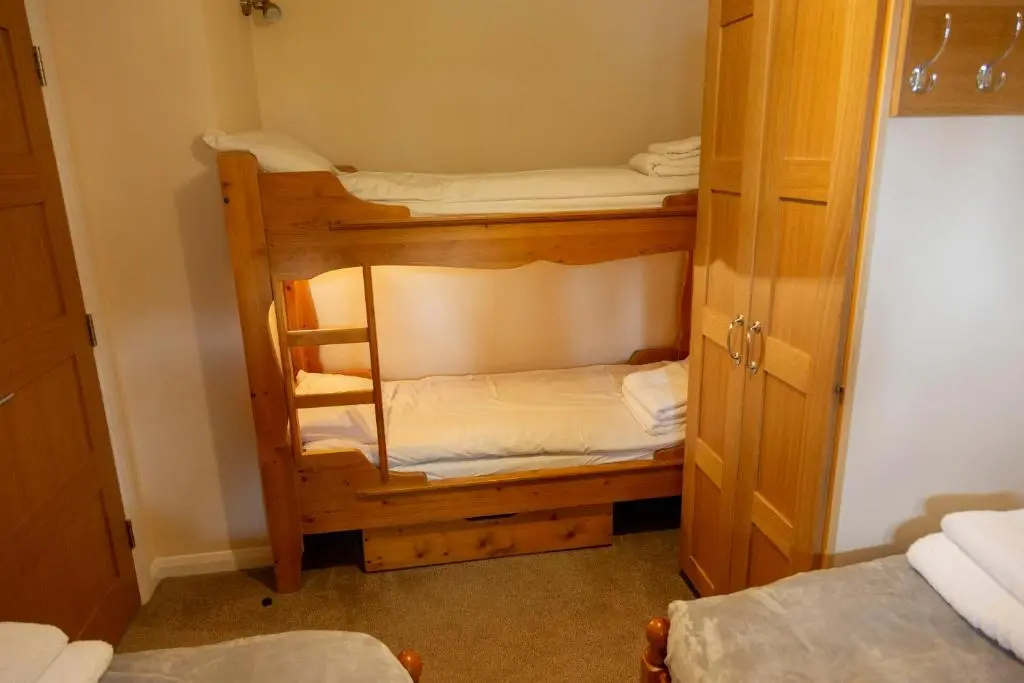 a bunk room with two bunk beds in it at Scandinavian Village Ltd in Aviemore