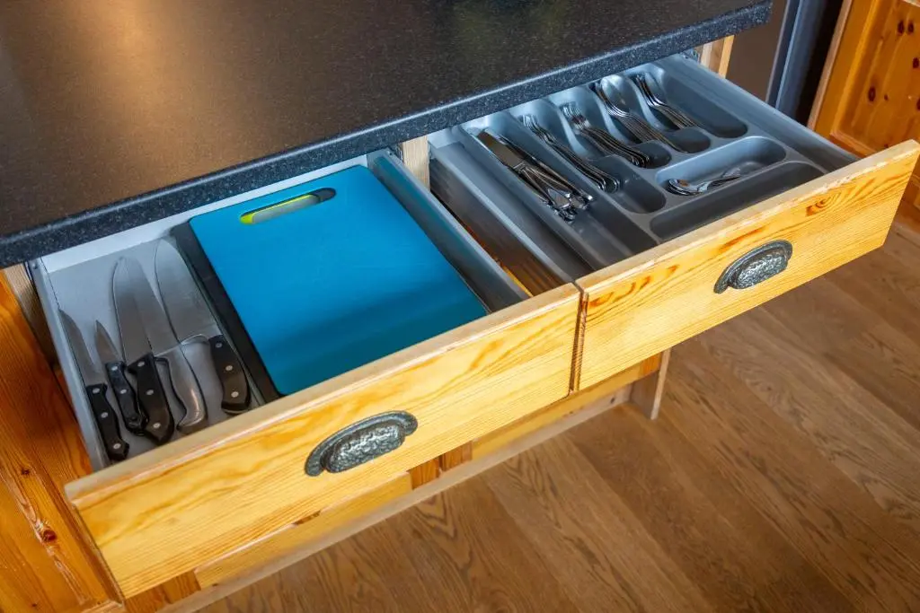 a drawer full of knives in a kitchen counter at Scandinavian Village Ltd in Aviemore