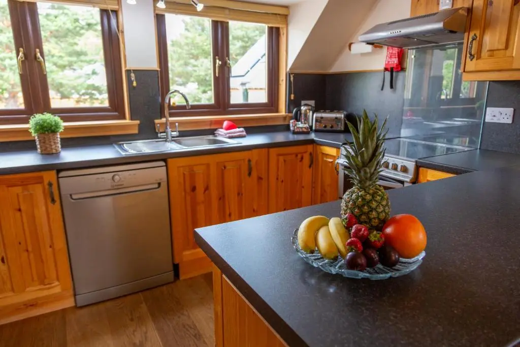 a bowl of fruit on a counter in a kitchen at Scandinavian Village Ltd in Aviemore