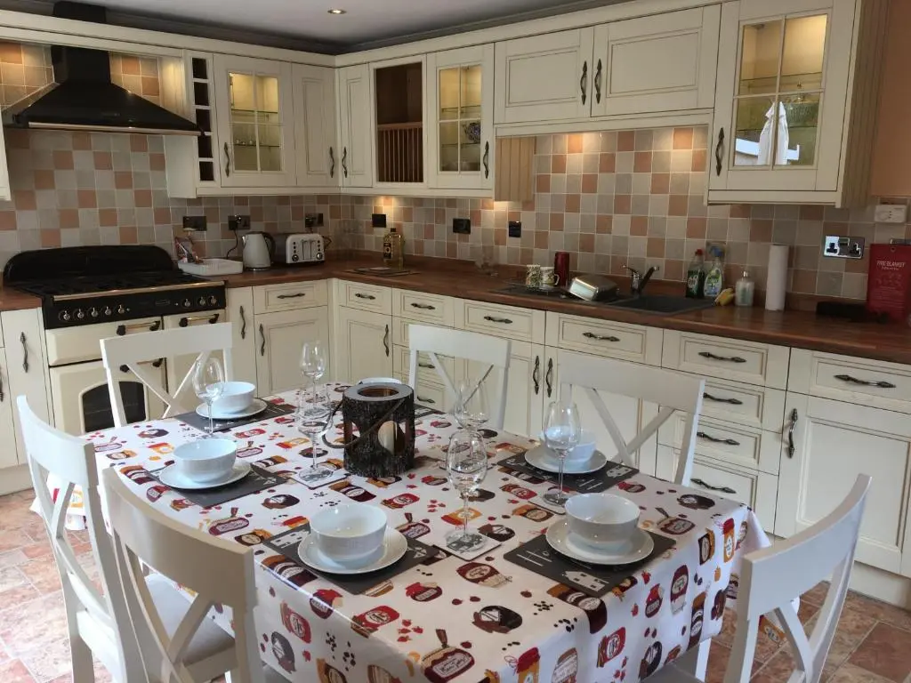 a kitchen with a table with a table cloth on it at Crescent Corner, Inverness in Inverness