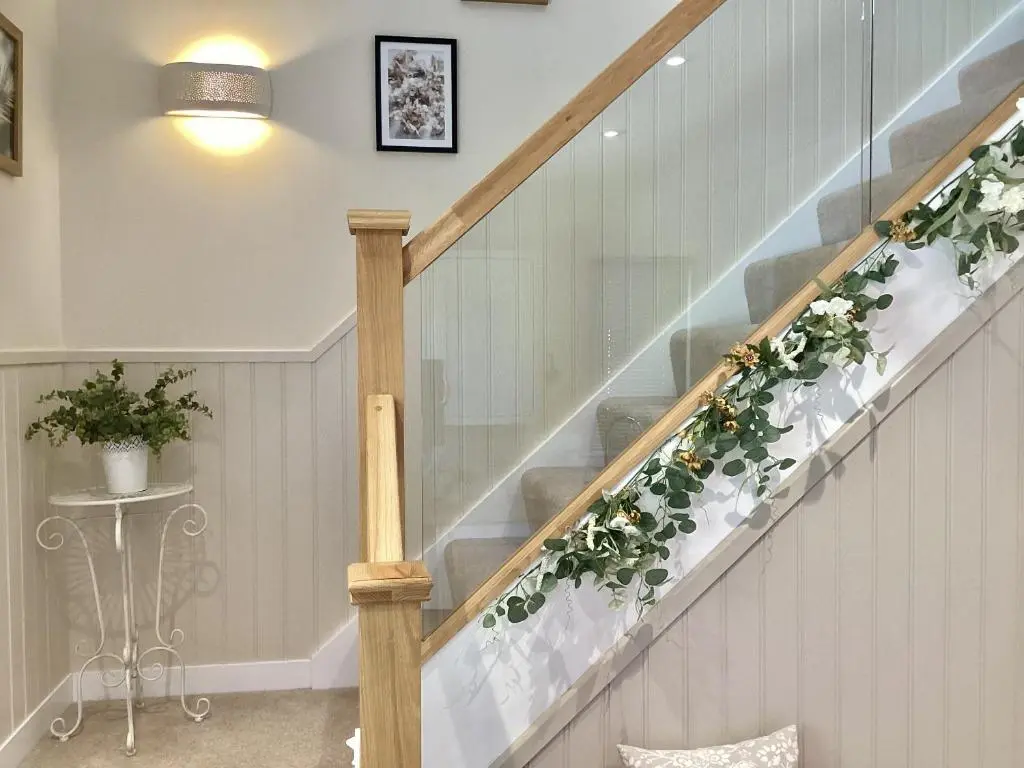 a stairway with a flower arrangement on it at Larchwood Lodge in Ellon