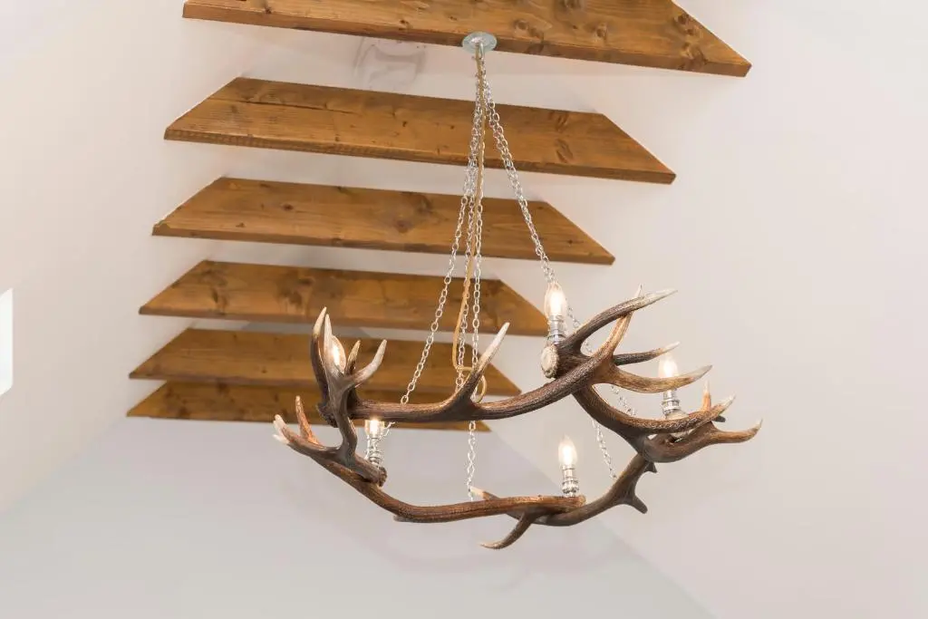 a chandelier with antlers hanging from a wall at The Milking Sheds, Dufftown in Dufftown