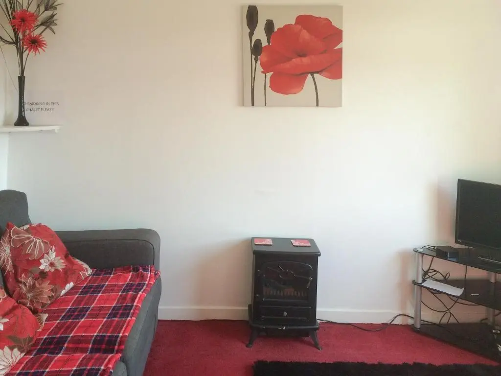 a living room with a couch and a fire place at Loch Ness - Uk7094 in Contin