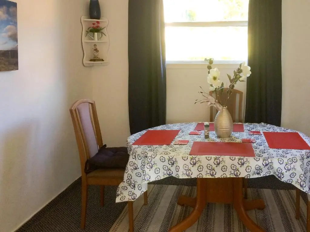 a dining room table with a vase of flowers on it at Loch Ness - Uk7094 in Contin
