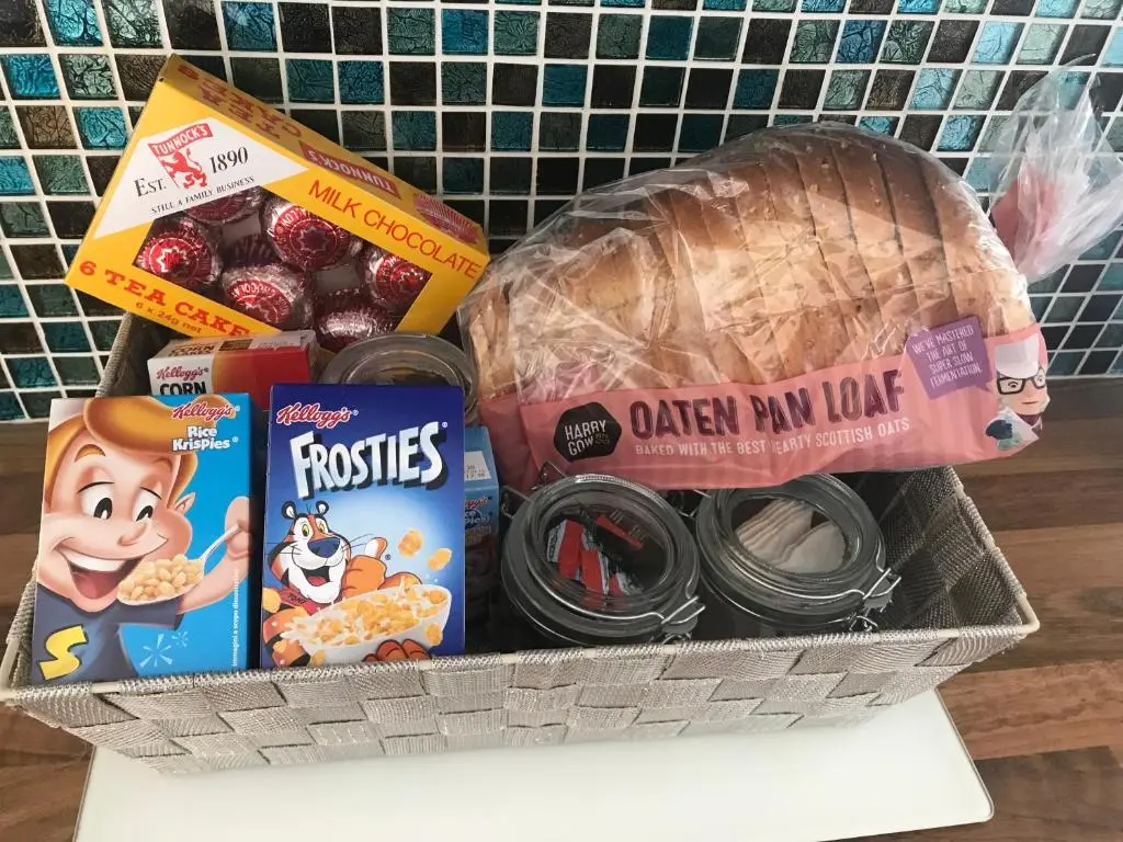 a basket with some food and other food items at Ardentorrie Holiday Home in Inverness