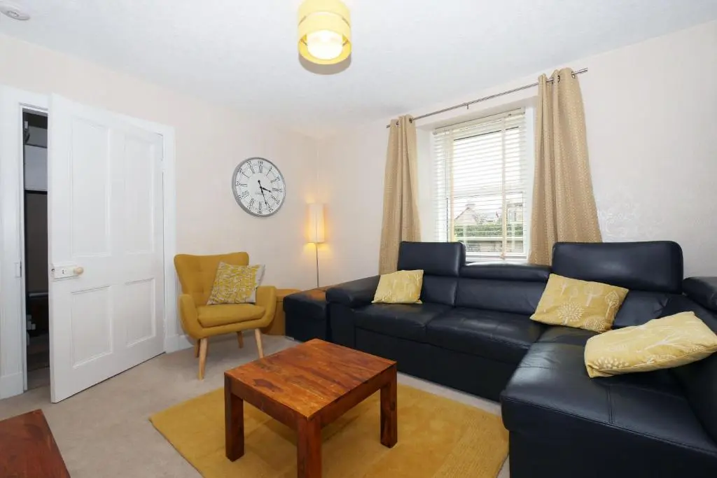 a living room with a couch and a table at Ardentorrie Holiday Home in Inverness