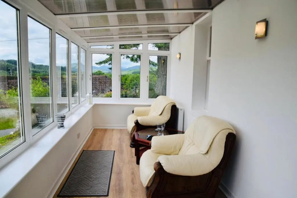 two chairs and a table in a room with windows at Balintombuie in Dalchreichart