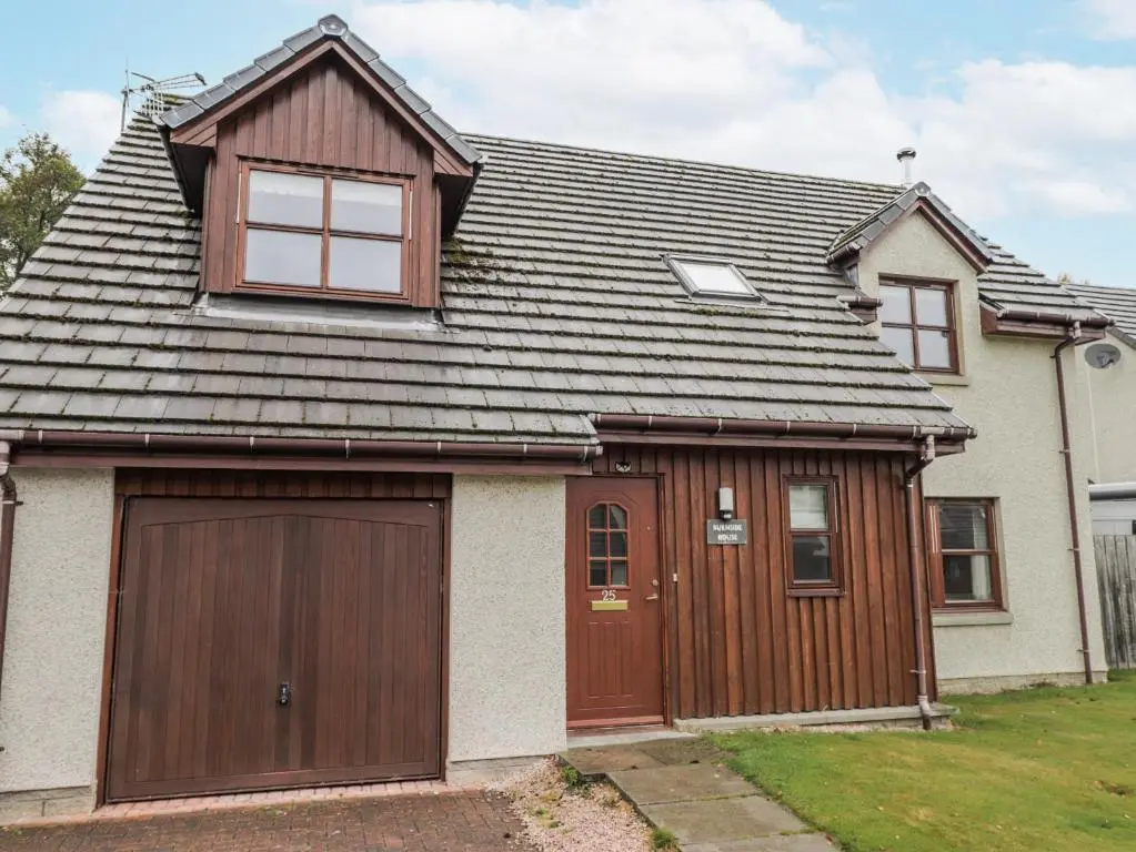 a house with a garage and a roof at Burnside House in Aviemore
