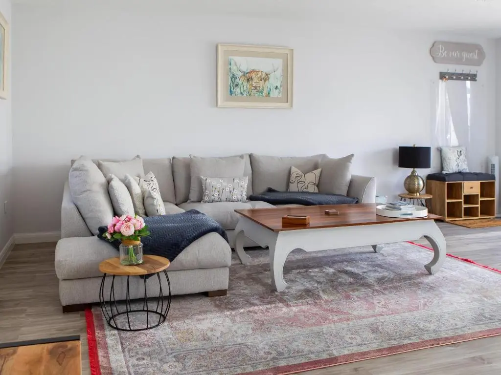 a living room with a couch and a coffee table at Rose Cottage in Dingwall