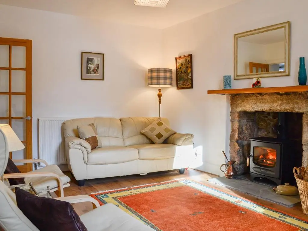 a living room with a couch and a fireplace at Craigclunie in Ballater