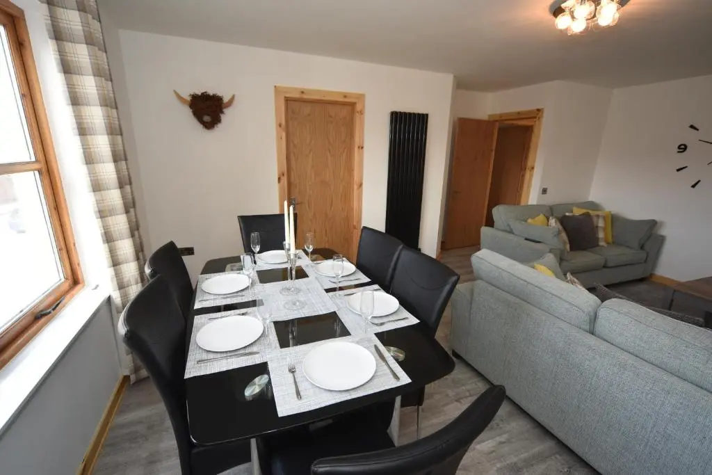 a living room with a table and a couch at Silver Key Apartment 2 in Inverness