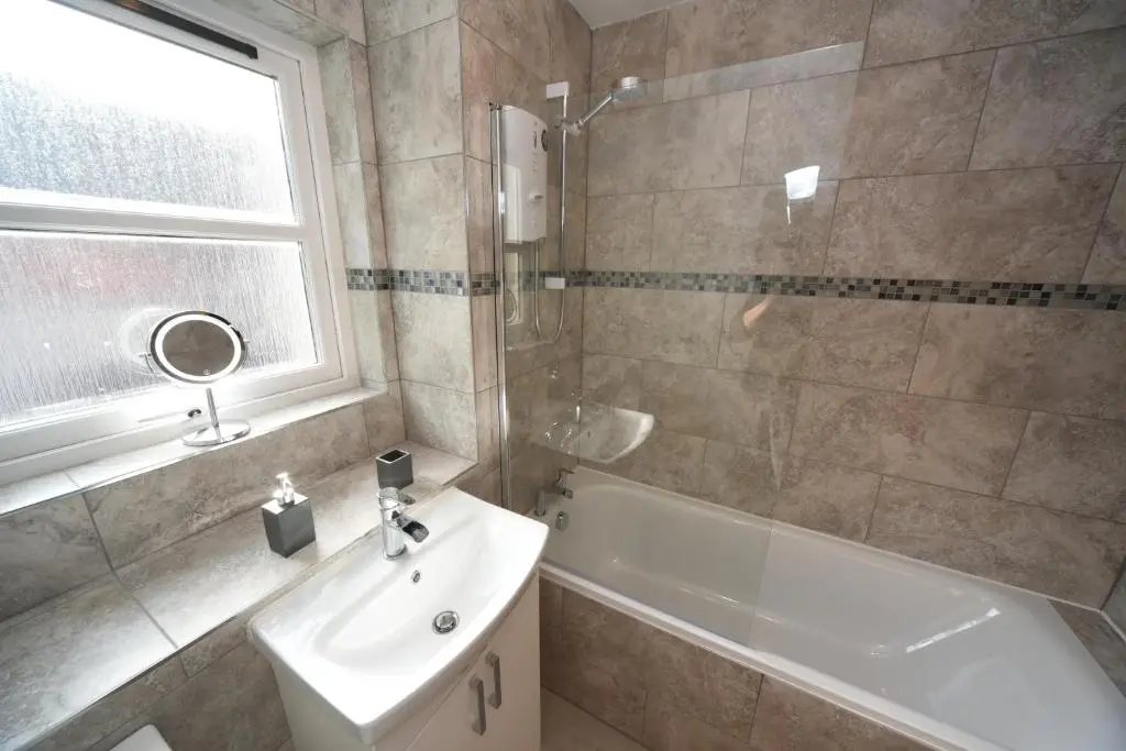 a bathroom with a sink and a tub and a shower at Silver Key Apartment 2 in Inverness