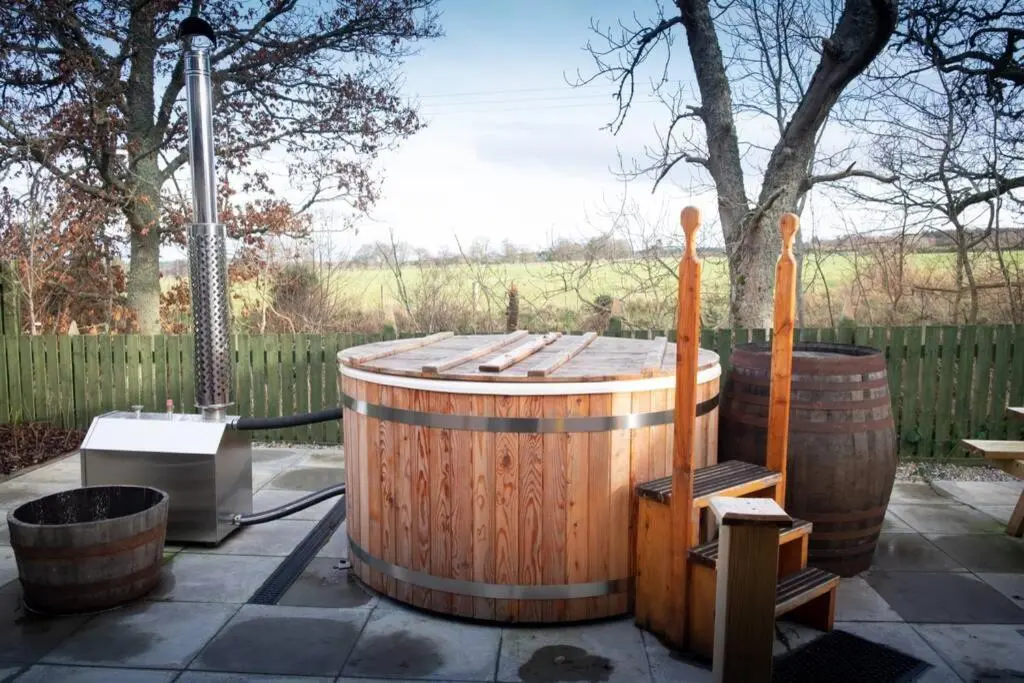 a wooden tub sitting next to two wooden barrels at Drumossie Bothy in Inverness