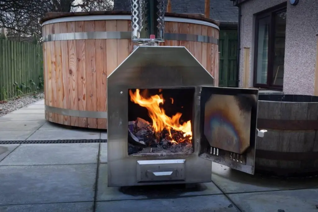 a outdoor oven with a fire in it on a sidewalk at Drumossie Bothy in Inverness