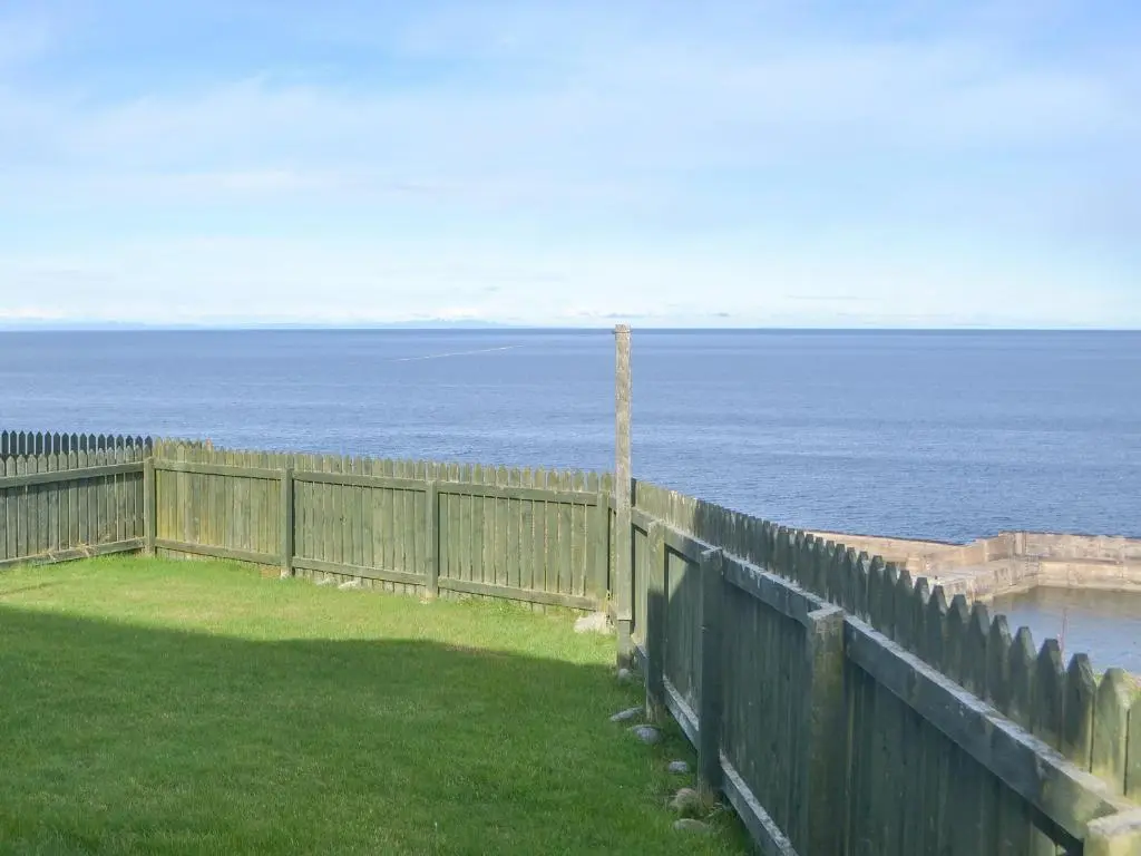 a view of the ocean from a fence at White Gables - Uk30688 in Portknockie