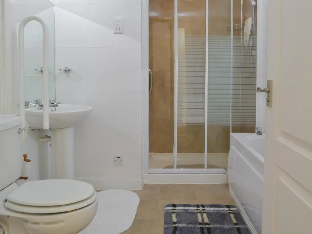 a white bathroom with a toilet and a shower at Dolphin View - Uk30689 in Portknockie