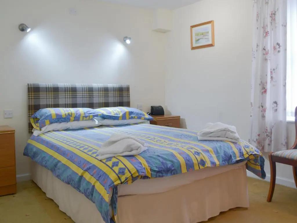 a bedroom with a bed with two towels on it at Seabreezes - Uk30690 in Portknockie