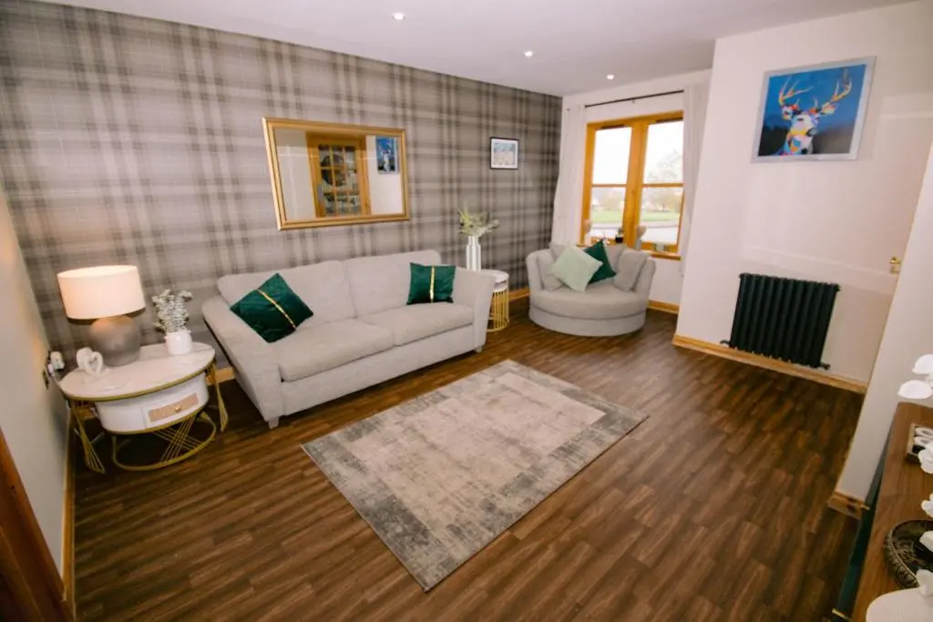 a living room with a couch and a table at Inverness Holiday House - 2 Bedroom in Inverness