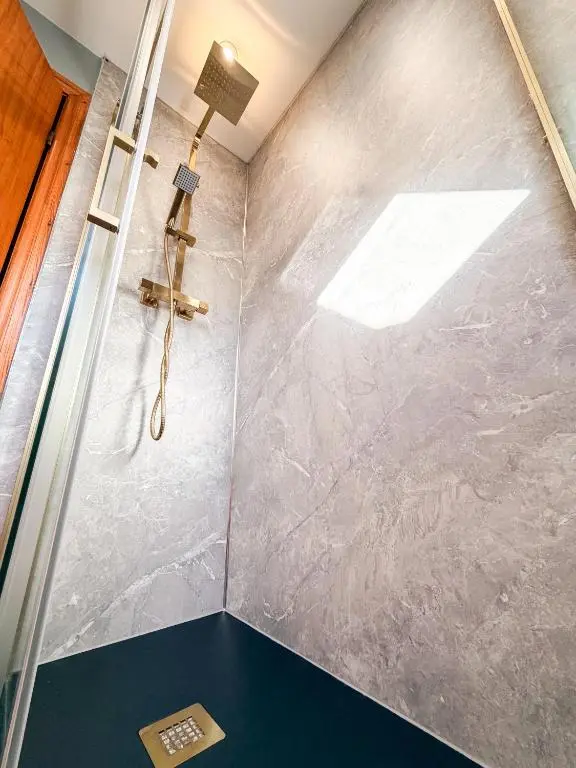 a shower in a bathroom with a glass door at Inverness Holiday House - 2 Bedroom in Inverness