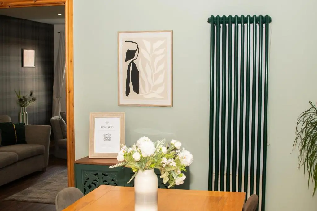 a vase of flowers on a table in a living room at Inverness Holiday House - 2 Bedroom in Inverness