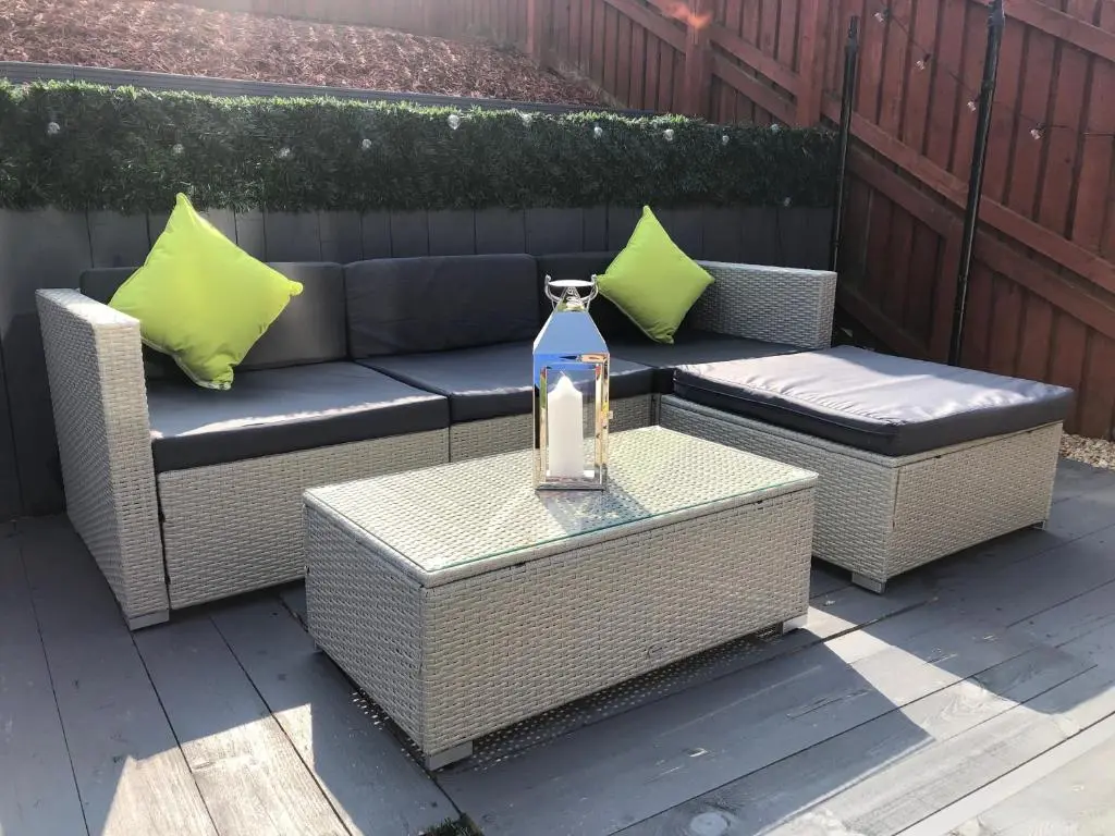 a blue bottle sitting on a table on a patio at Inverness Holiday House - 2 Bedroom in Inverness