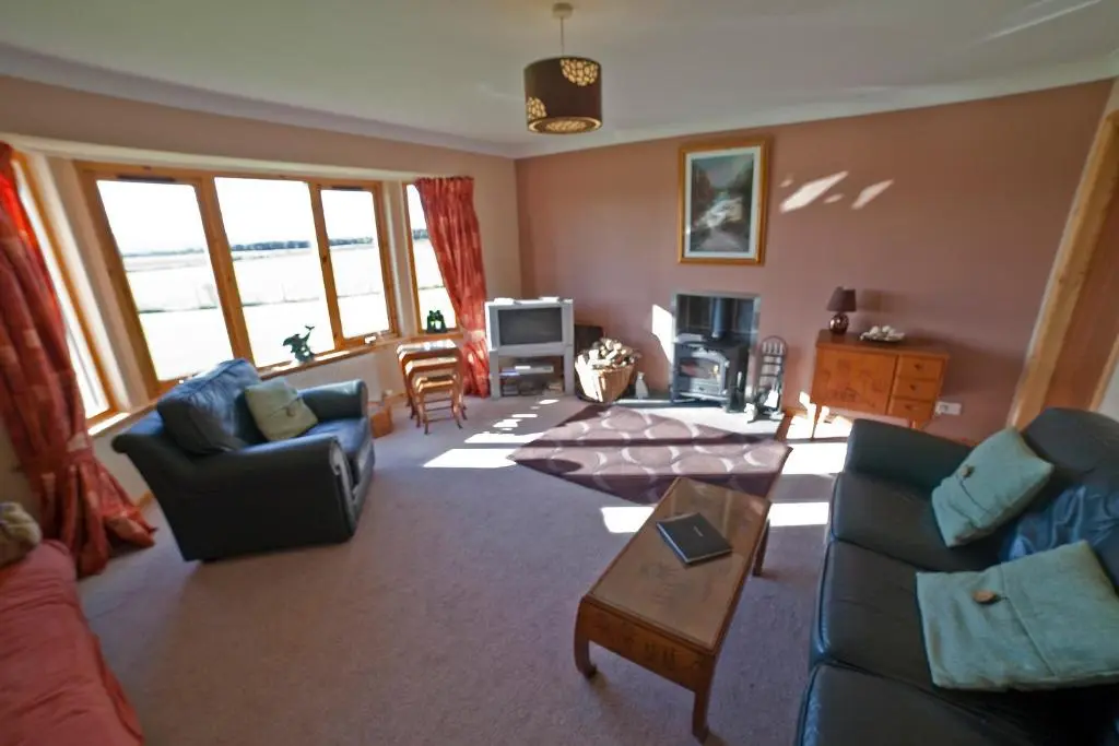 a living room with two couches and a table at Ard Garraidh in Ardersier