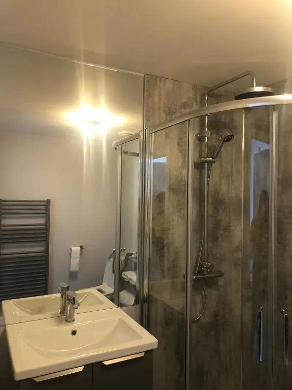 a bathroom with a sink and a shower at Appin Apartment in Inverness