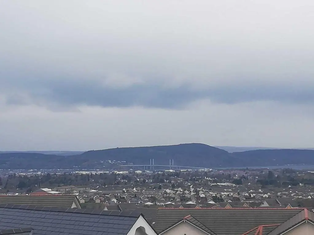 a view of a city with houses and mountains at Appin Apartment in Inverness